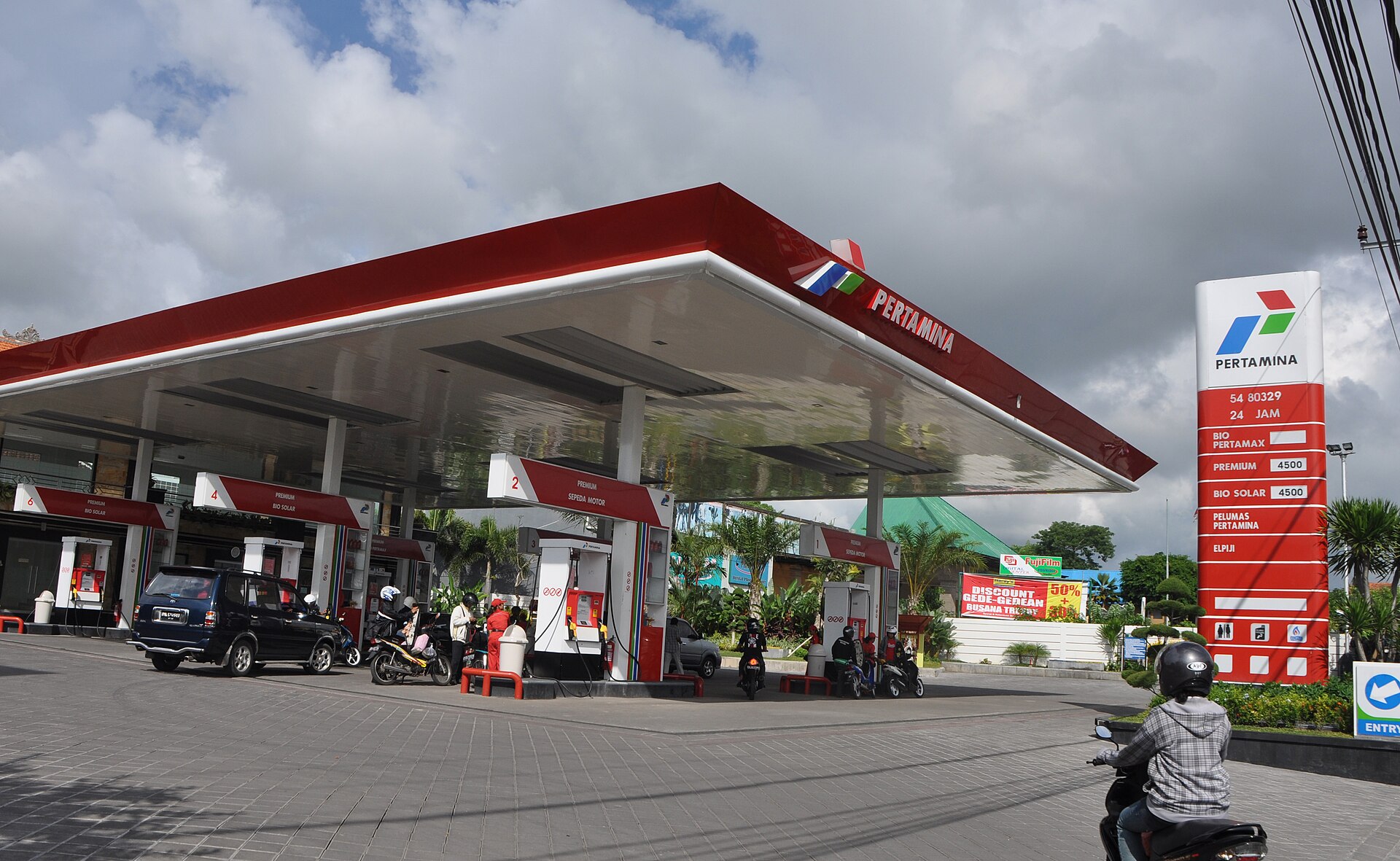Motorbikes and cars at a Pertamina petrol station in Bali, Indonesia