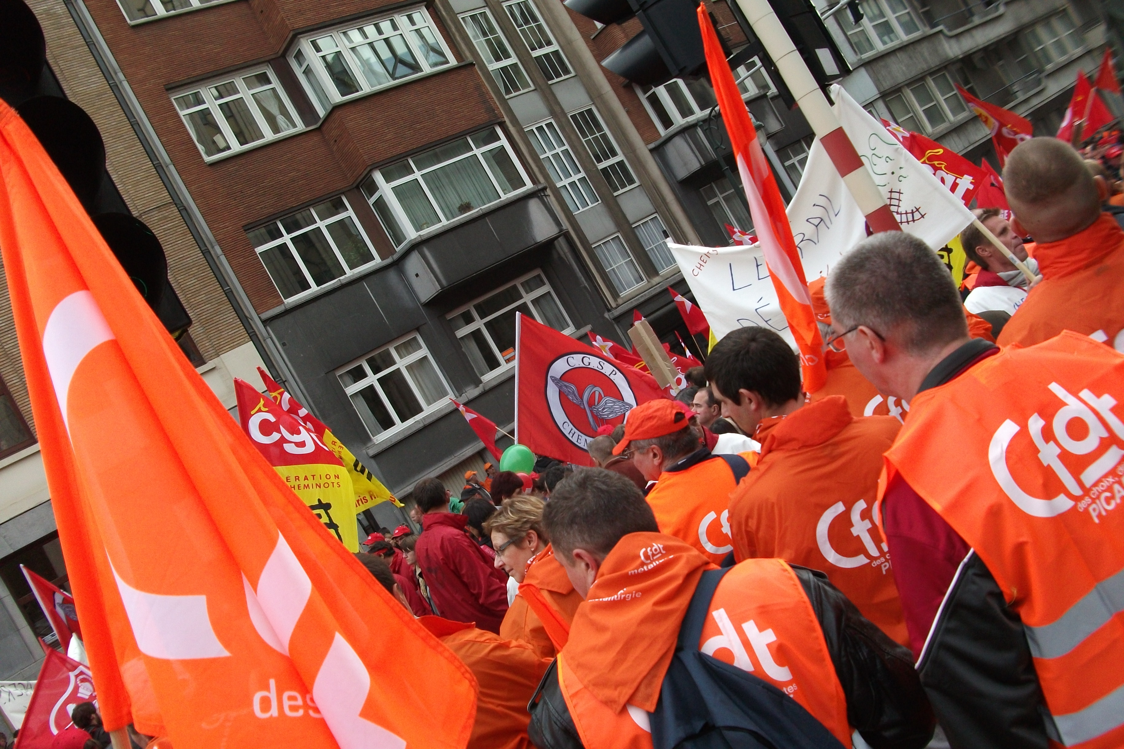 Union demonstrators with banners marching in a strike protest in Brussels