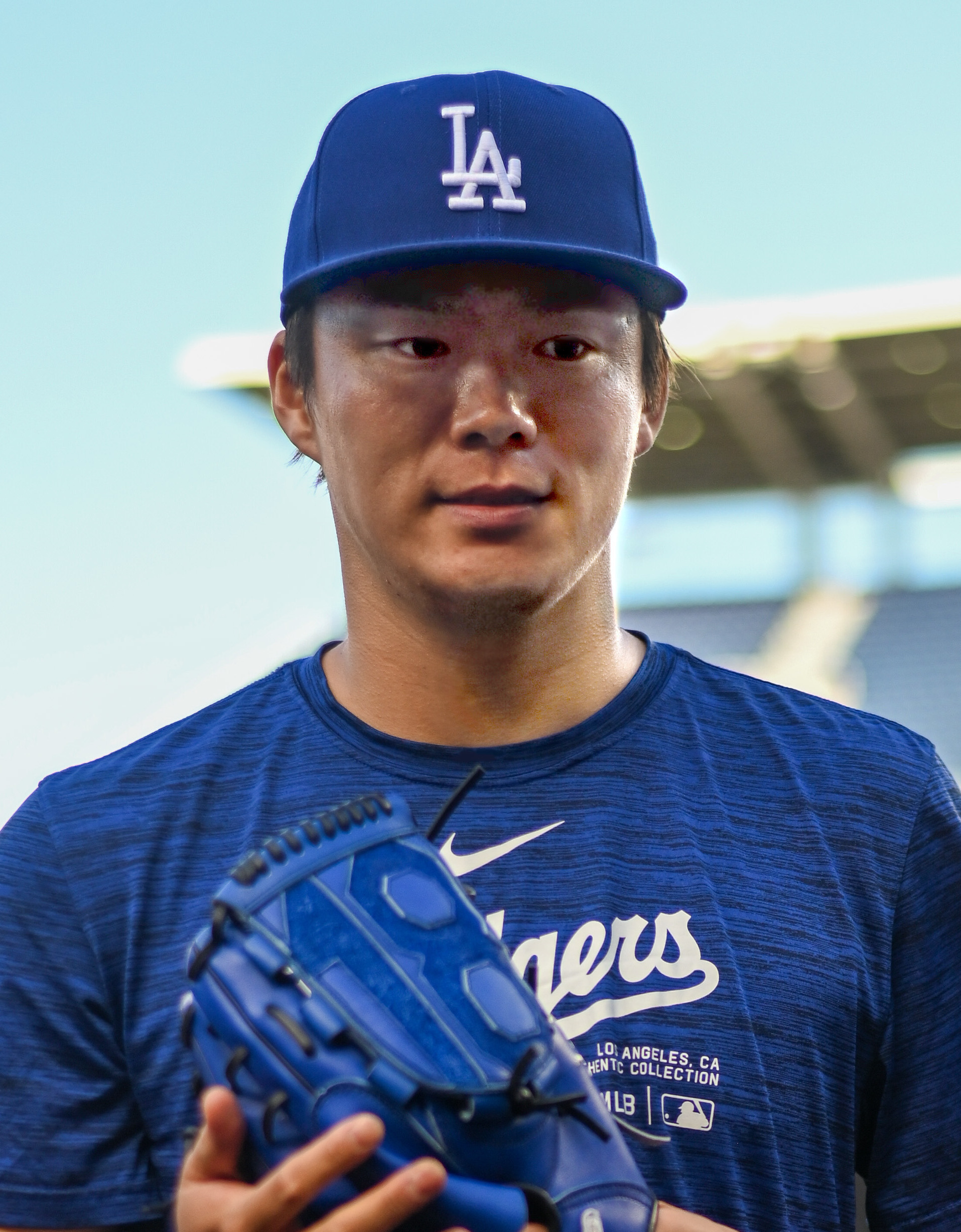 Yoshinobu Yamamoto in Los Angeles Dodgers gear holding his glove — NLCS Game 2 highlights file photo