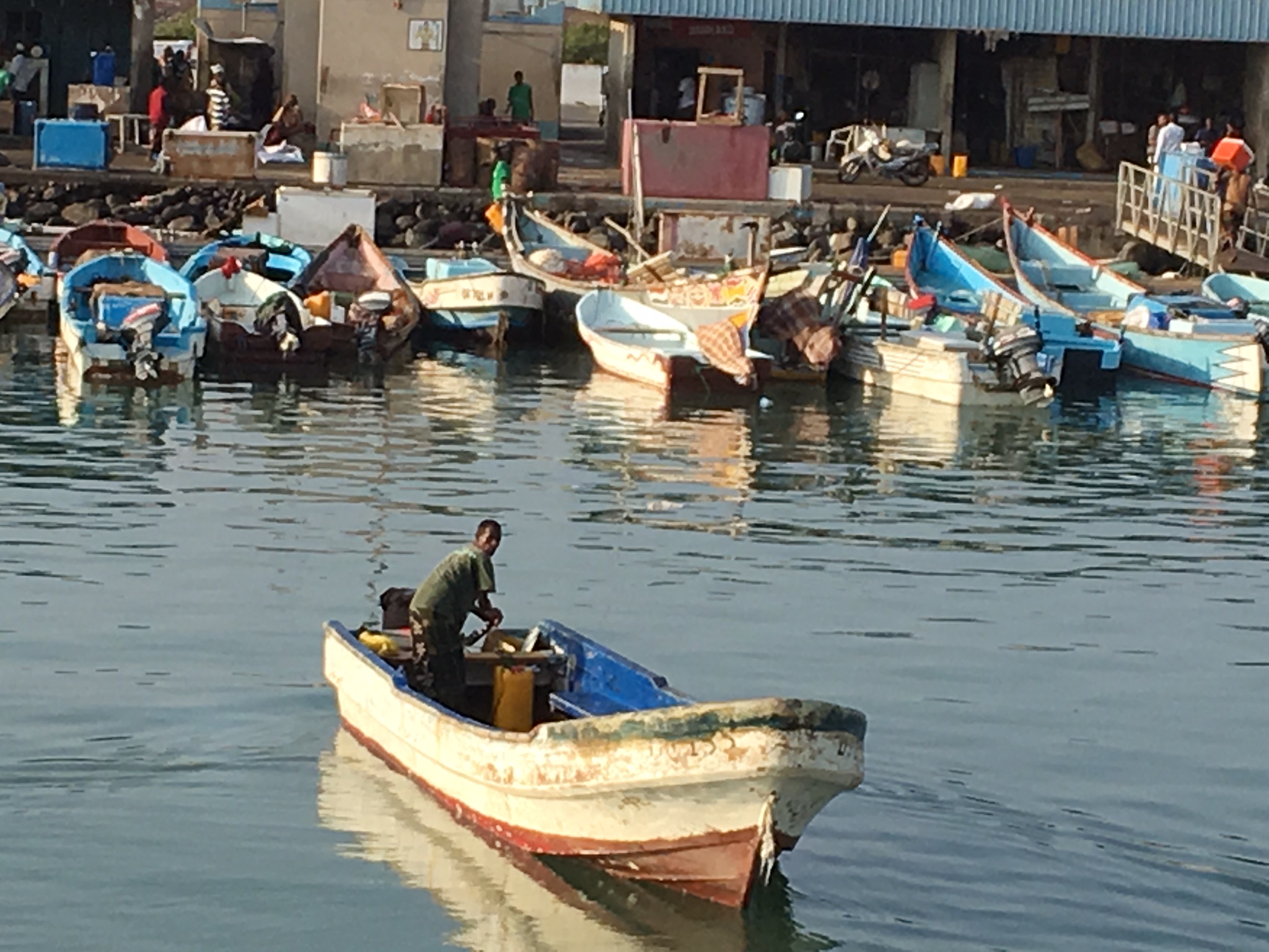 Small wooden fishing boats moored in a Djibouti harbor