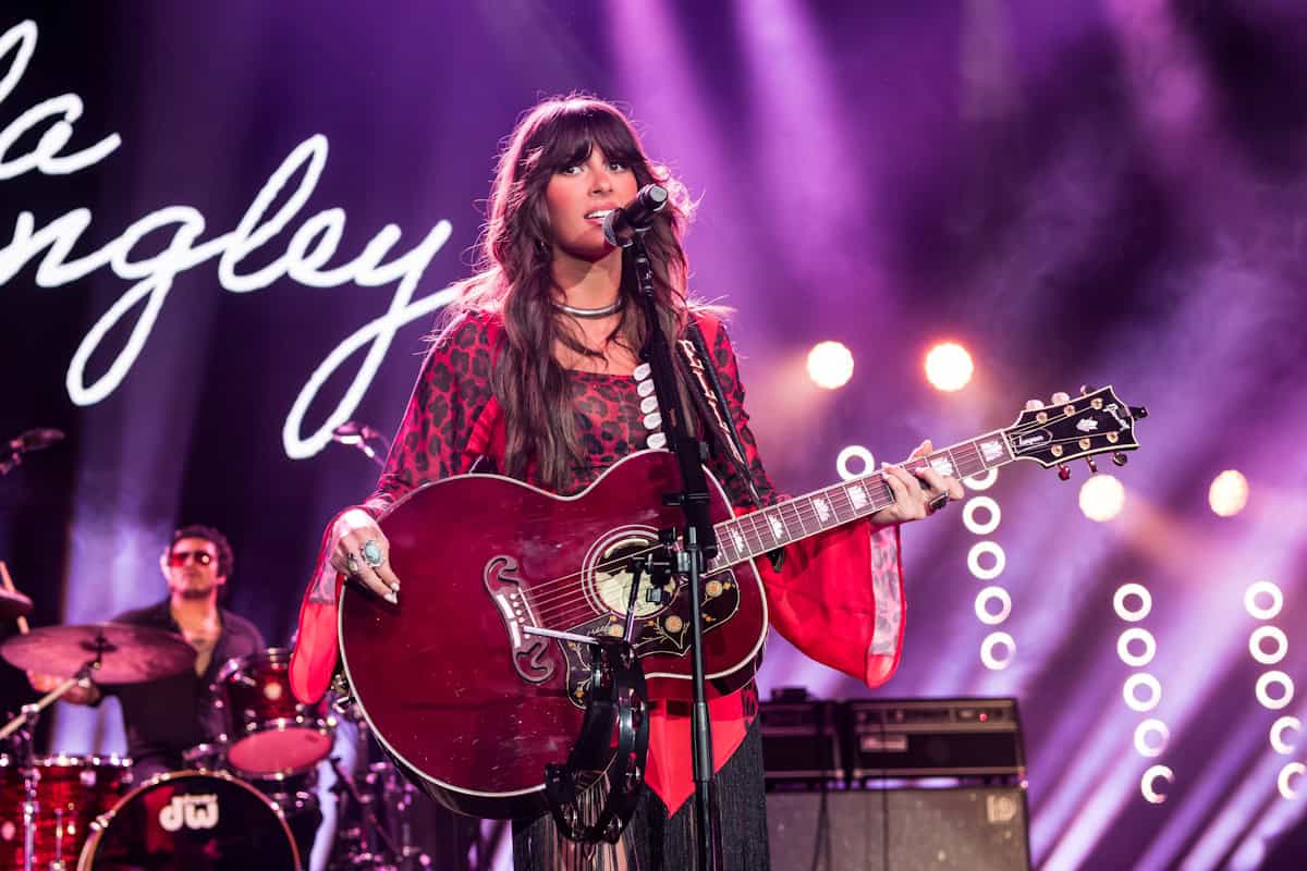 Ella Langley singing and playing guitar during a 2026 country music performance