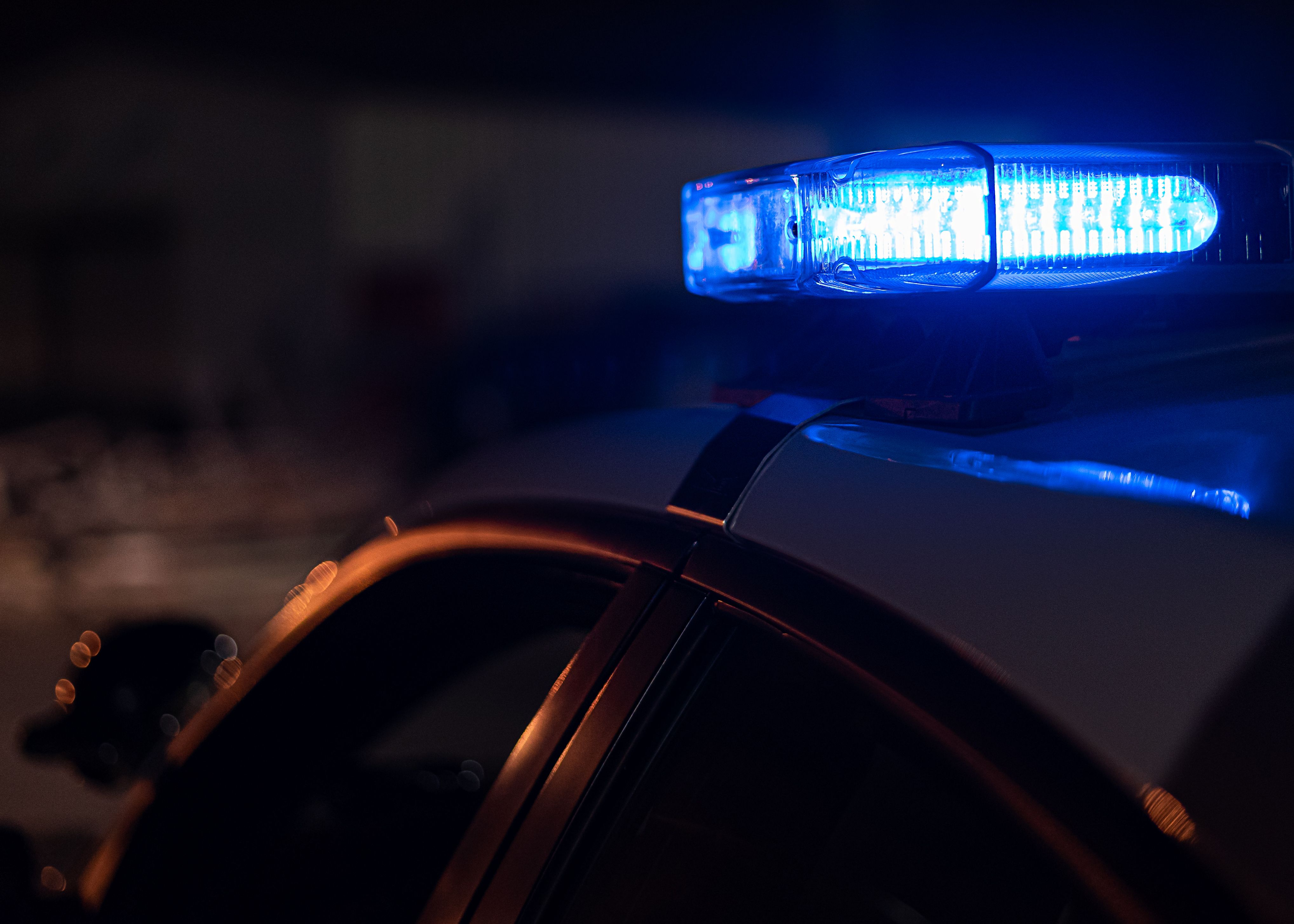 Blue emergency lights on a police vehicle at night