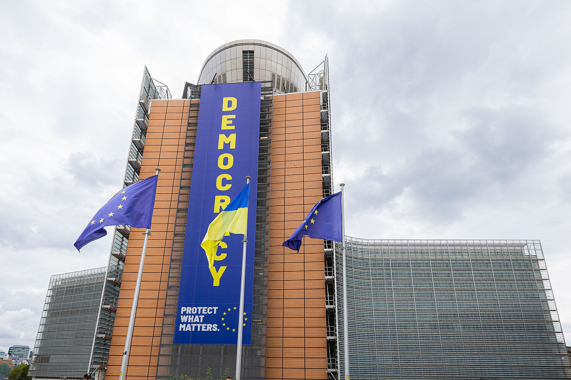 European Union and Ukrainian flags flying side by side in Brussels in front of an EU building, Ukraine EU accession talks