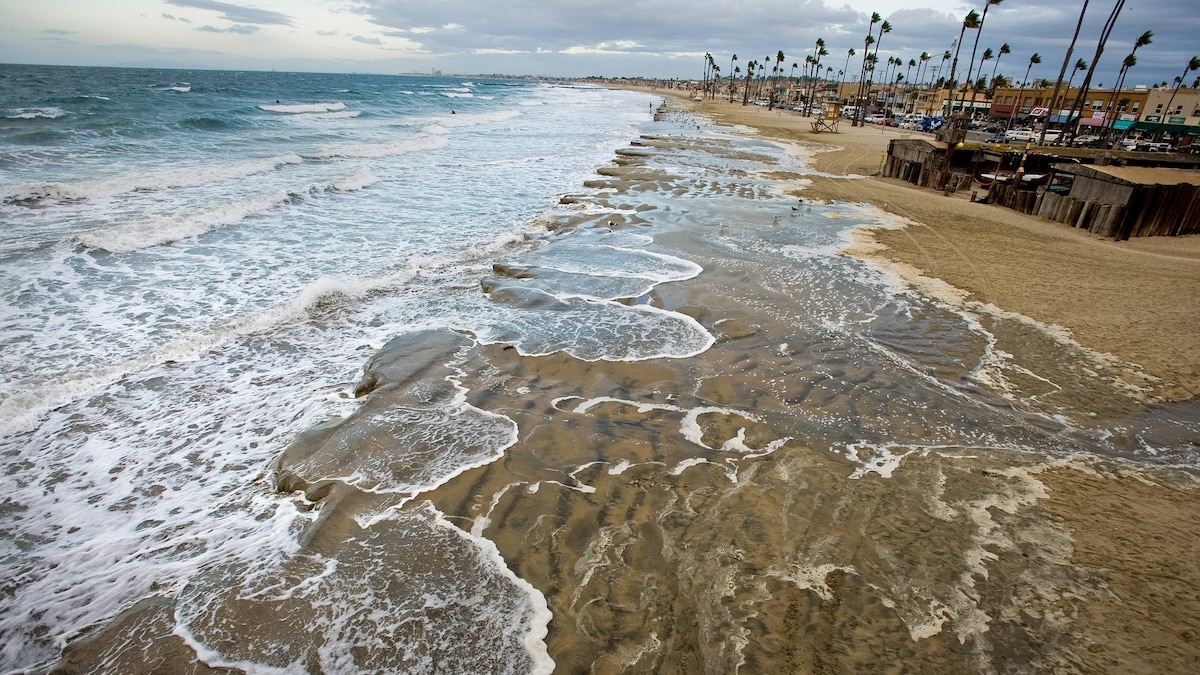 King tide flooding over a coastal roadway