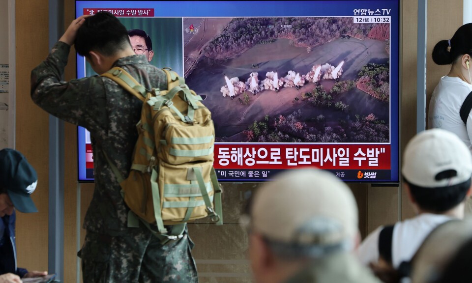 Travellers at Seoul Station watching a television news report on the North Korea missile launch of October 12 2026