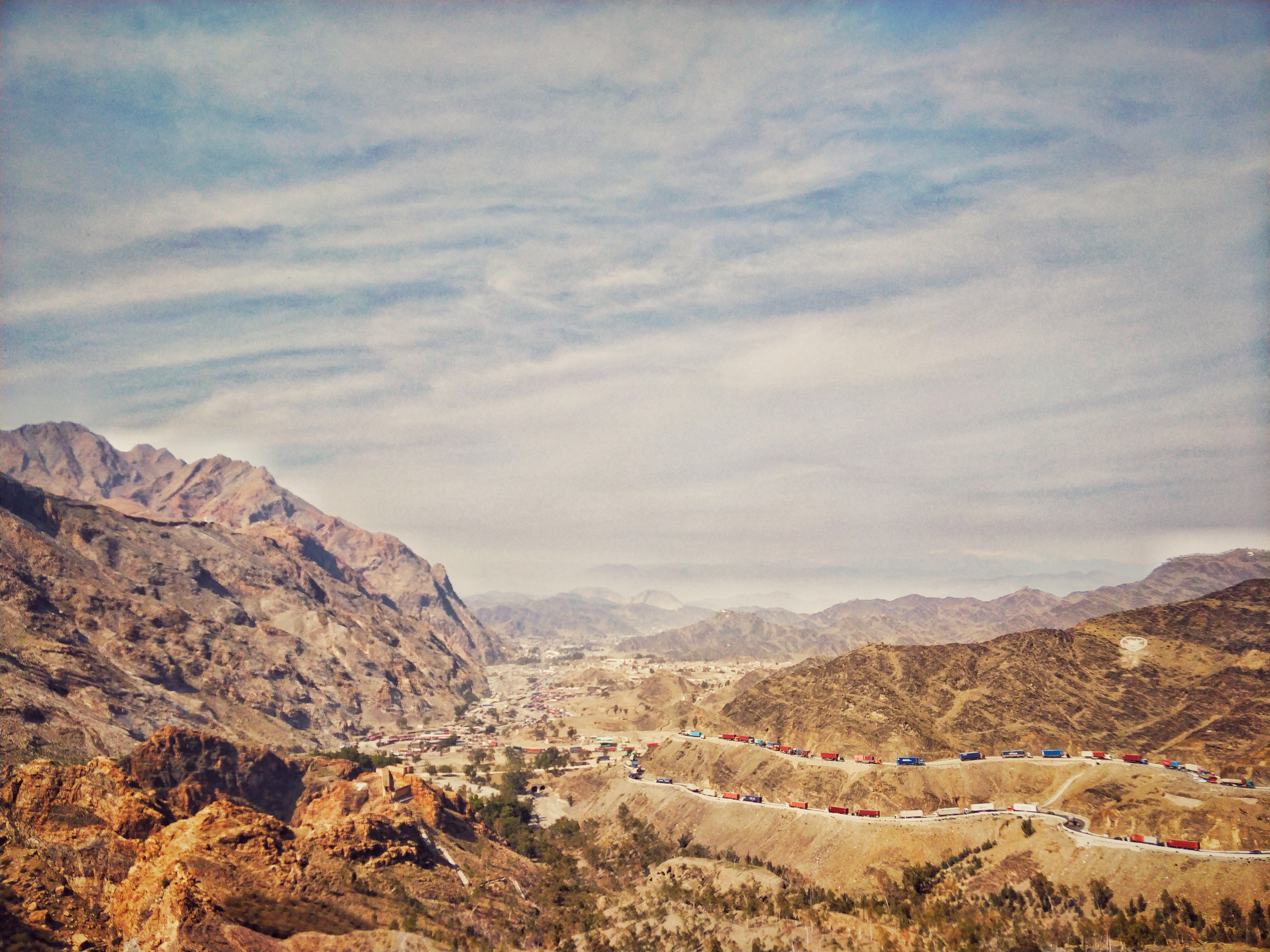 Truck convoys on the mountain road through the Khyber Pass near the Torkham border crossing with Afghanistan