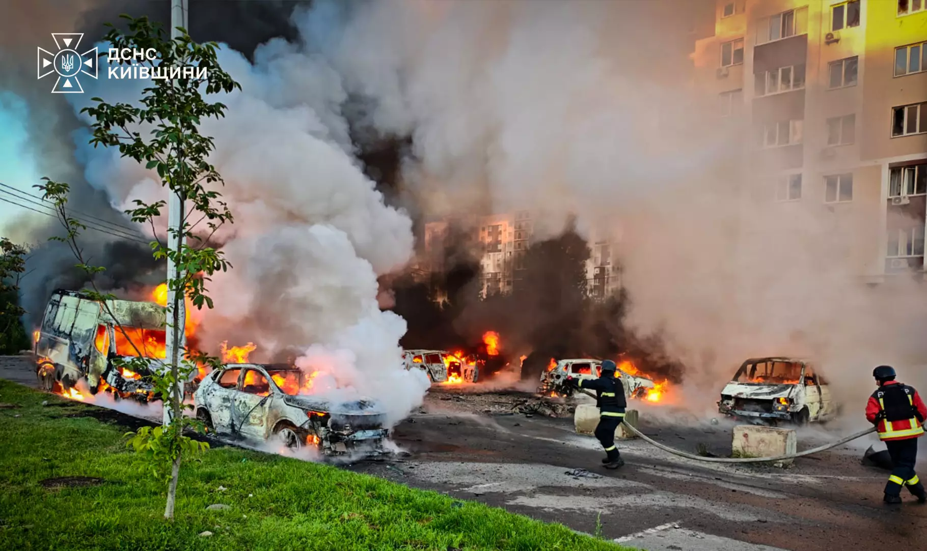 Firefighters spraying burnt-out vehicles after a drone strike in Vyshneve in the Kyiv region — McDonald's warehouse Kyiv drone strike file photo