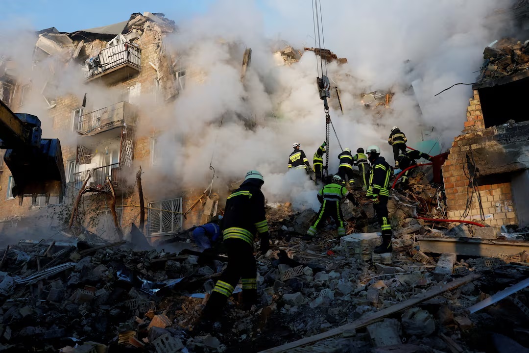 Rescuers working in the rubble of a Kyiv apartment building destroyed in an earlier Russian strike — Kyiv apartment block missile strike file photo
