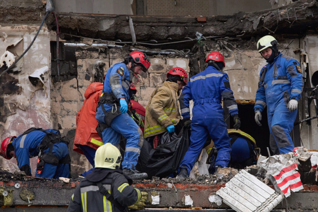Rescuers recovering a victim from a Kyiv building destroyed in an earlier Russian strike — Kyiv missile strike Wednesday file photo