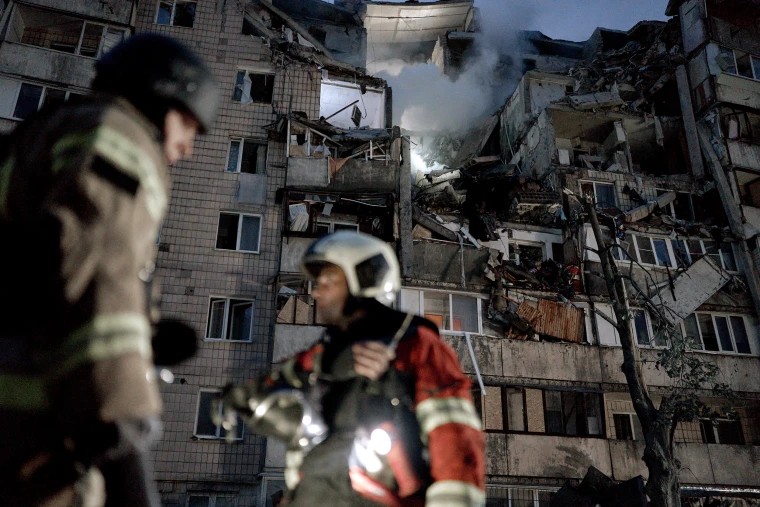 Firefighters in front of a Kyiv apartment block destroyed in an earlier Russian strike — Russian strikes Kyiv energy facilities file photo