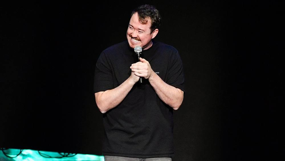Shane Gillis performing stand-up comedy onstage