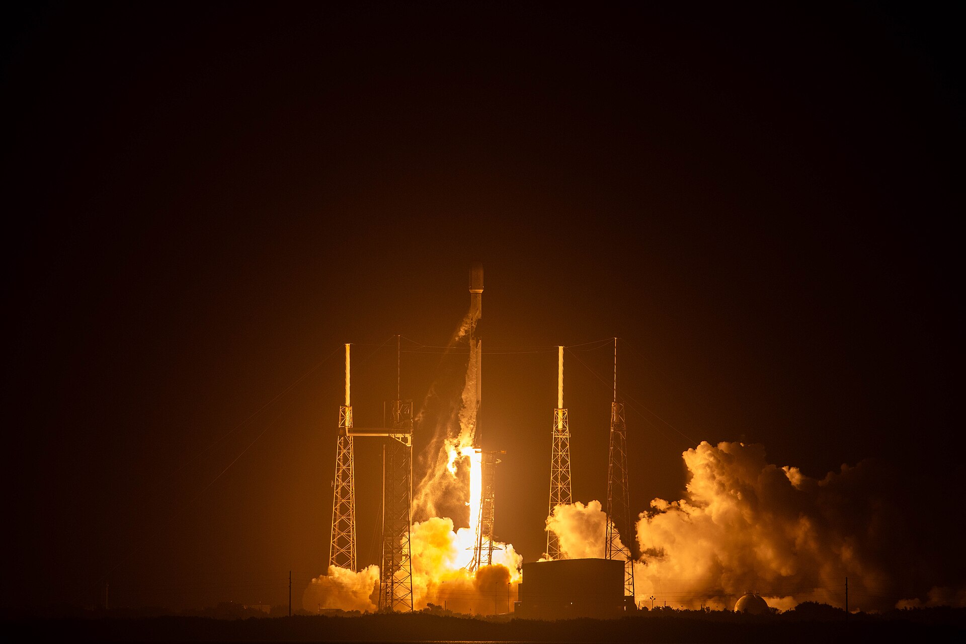 A Falcon 9 rocket launching Starlink satellites at night on the Starlink 10-59 mission, SpaceX Starlink constellation