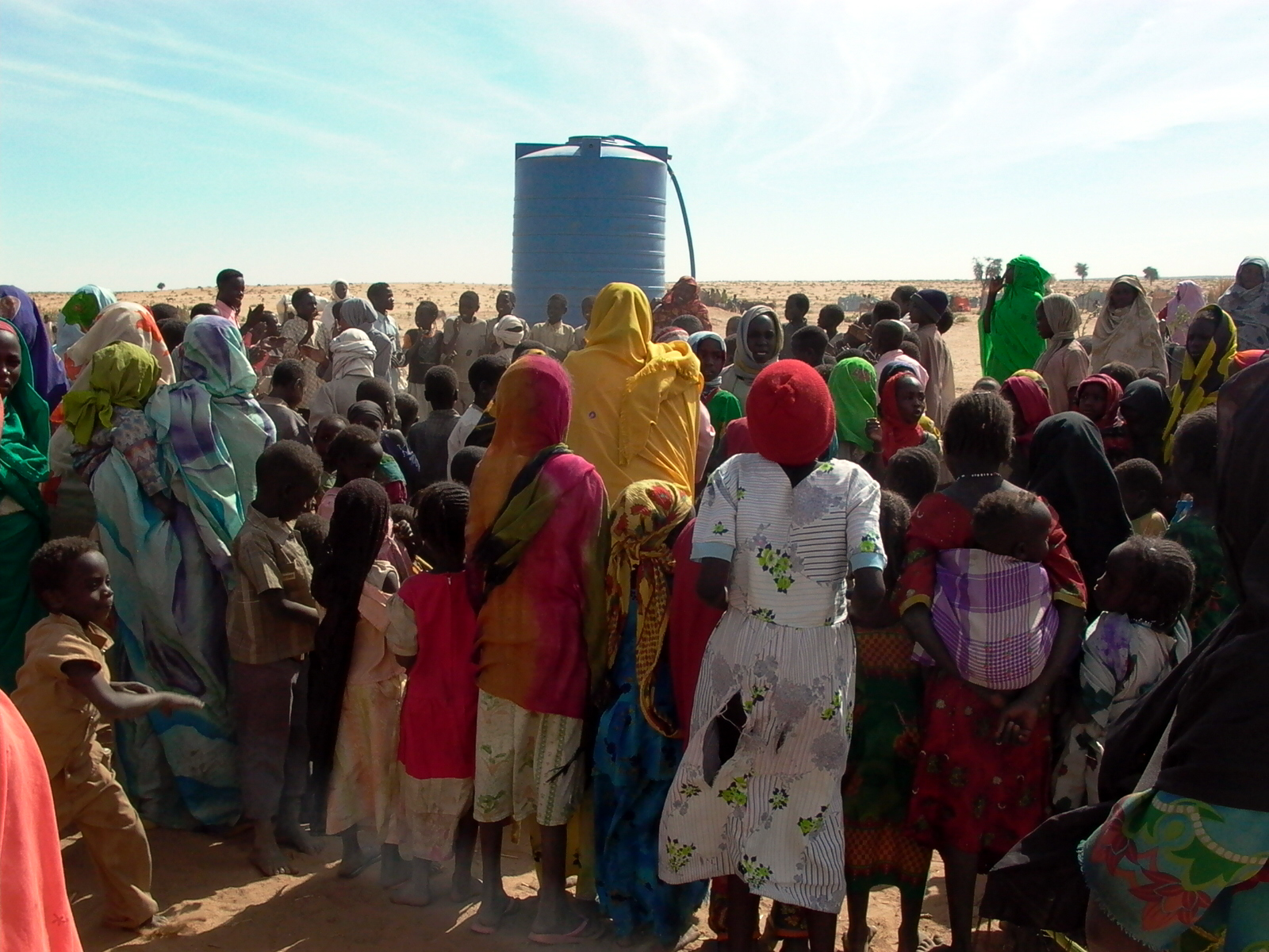 Displaced Sudanese people collecting water at a camp in West Darfur