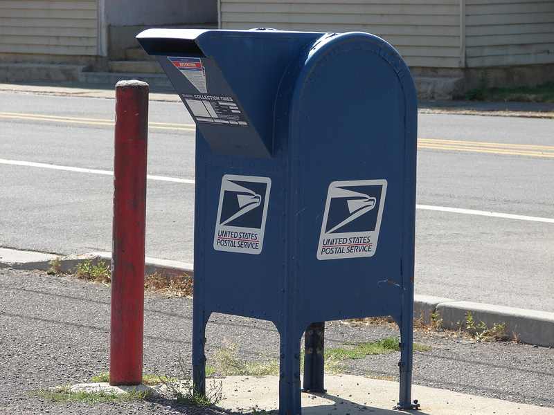 A blue USPS collection mailbox — Trump's $500 Obamacare refund checks are arriving by mail with no application needed