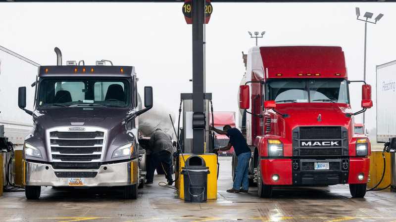 Truck drivers fueling semi-trucks as diesel prices remain elevated