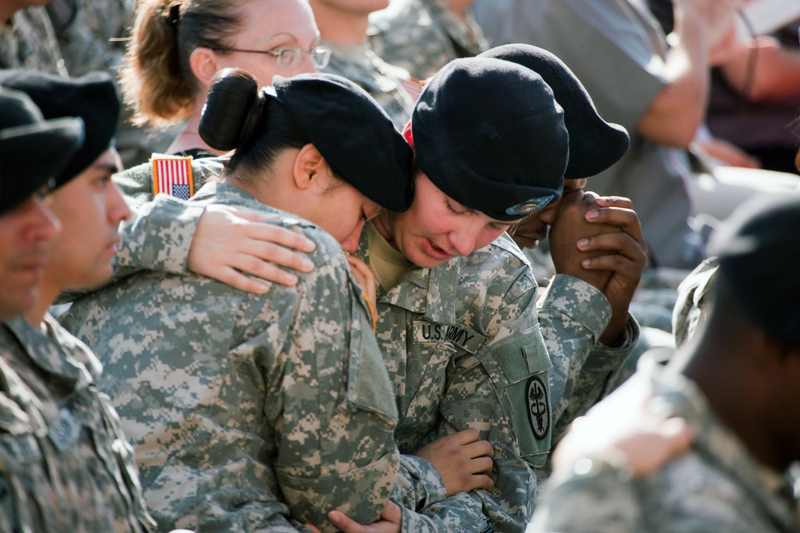 Soldiers comfort one another at the 2009 Fort Hood memorial service for the shooting victims