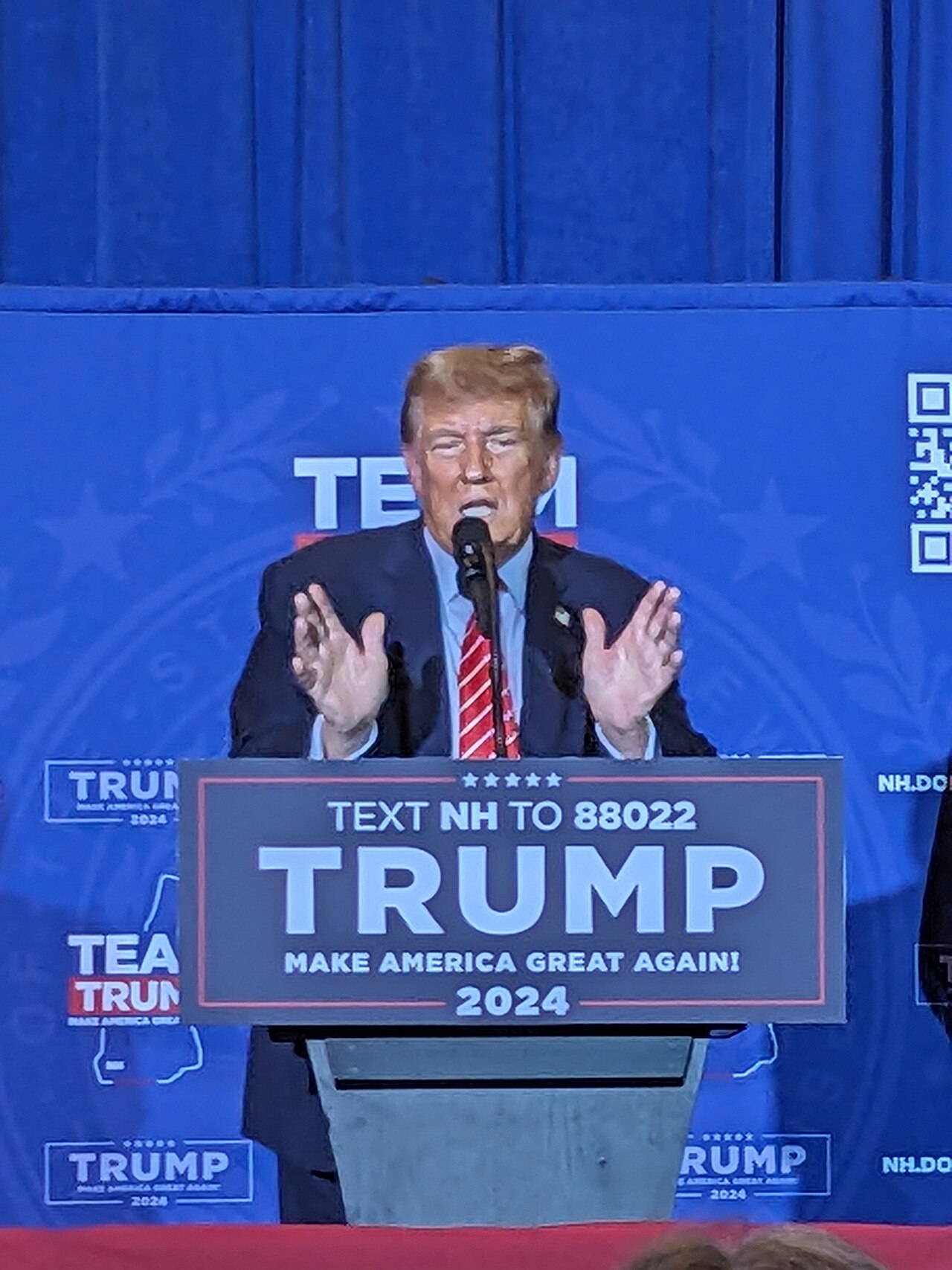 Donald Trump speaking at a campaign rally podium, Trump Youngstown rally Husted immigration