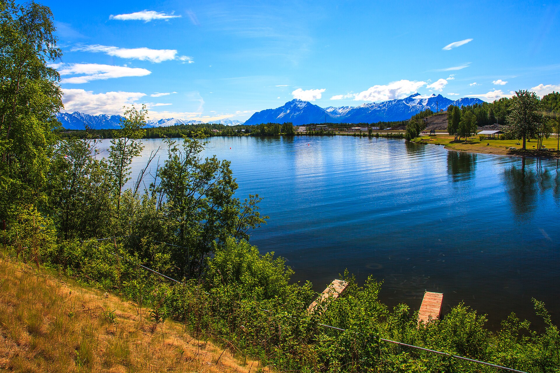 Wasilla Lake in Wasilla Alaska with the Talkeetna Mountains beyond, Curtis D Menard Memorial Sports Center rally