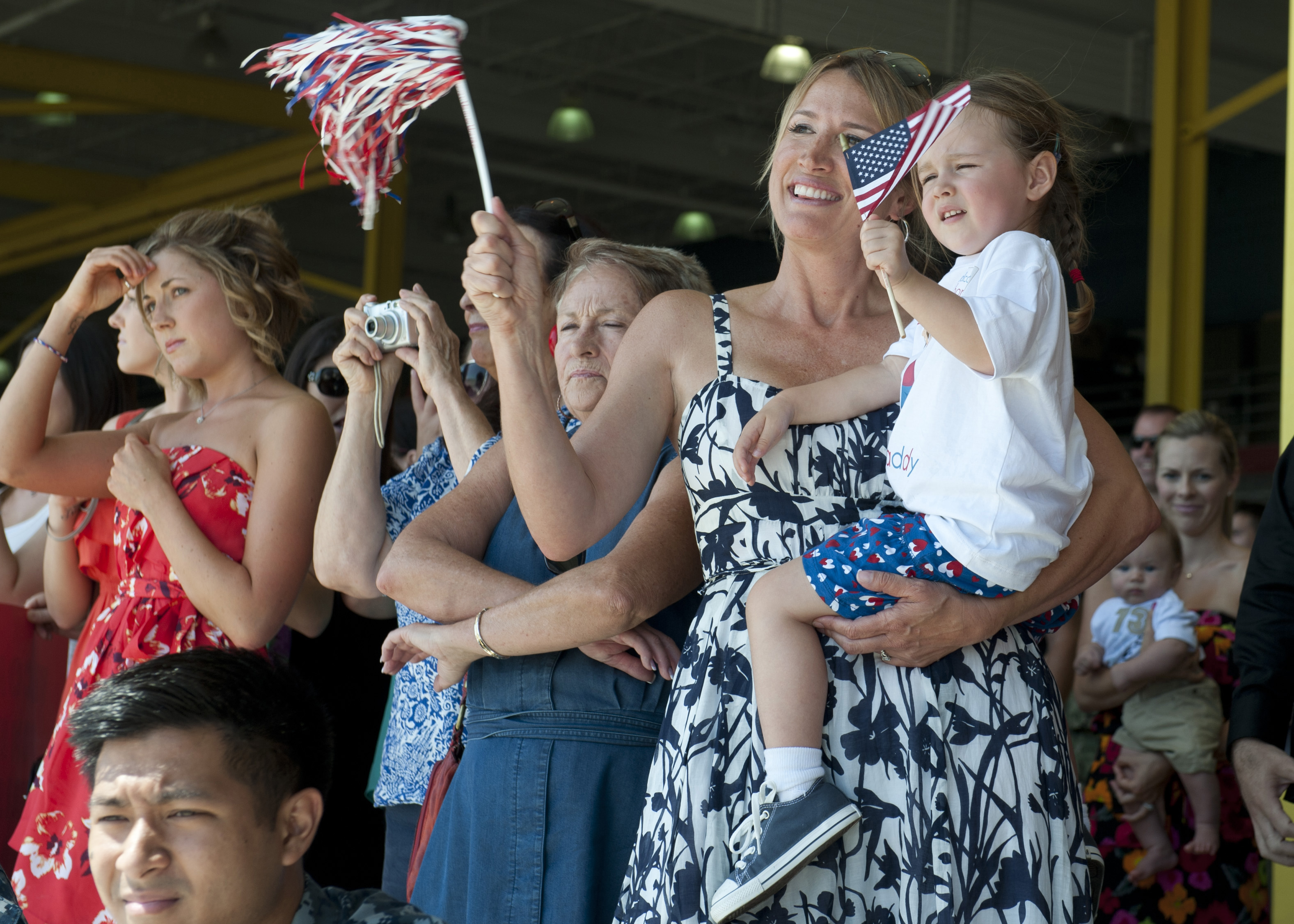 Family and friends of Navy sailors celebrate a squadron homecoming in San Diego