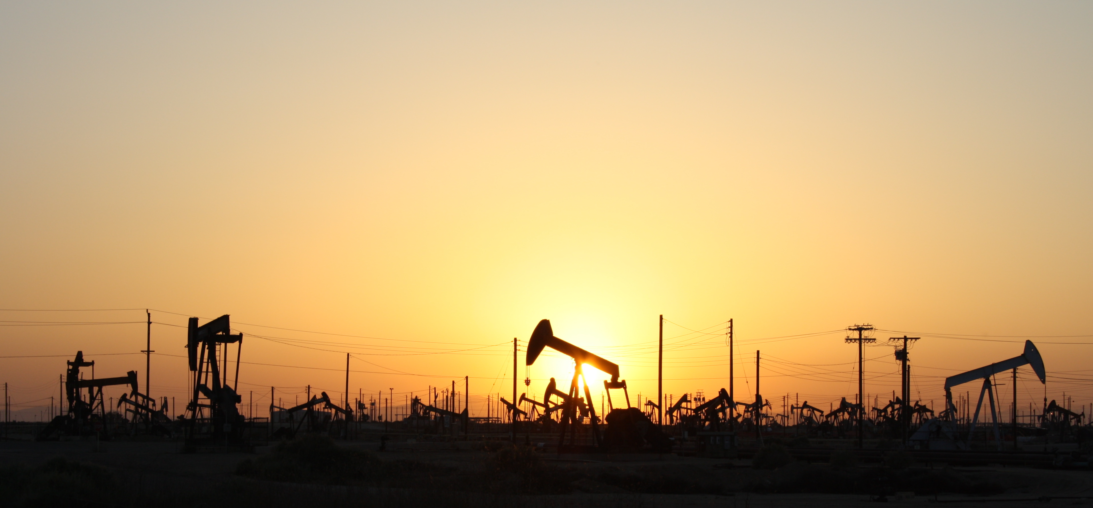 Oil pumpjacks at work as crude trades near $100 a barrel, adding an energy-driven twist to the week's September CPI inflation data