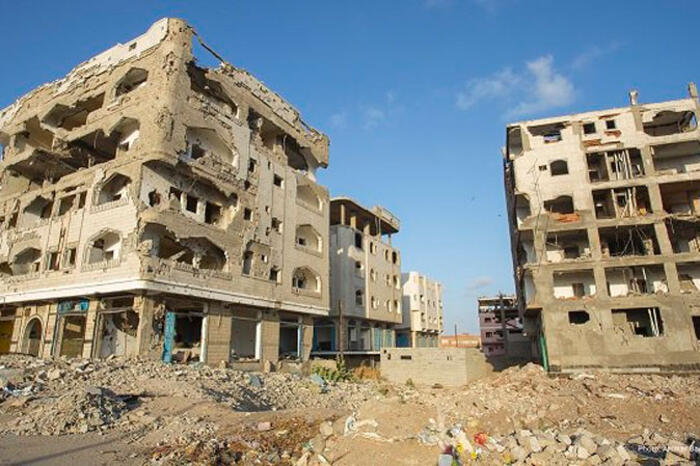 Conflict-damaged buildings along a World Food Programme convoy route inside Taiz, Yemen
