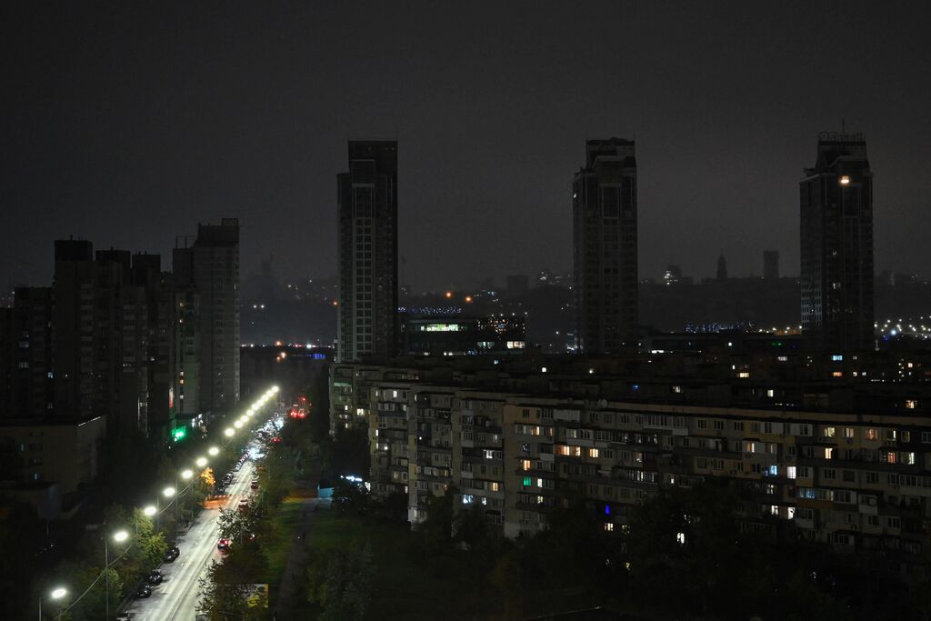 Kyiv residents moving through a darkened street during a previous power outage