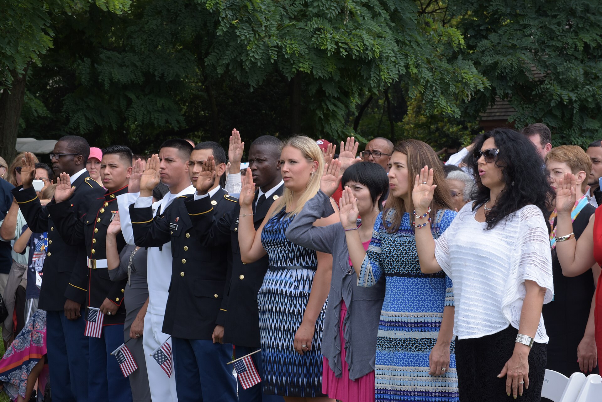 New citizens take the oath of allegiance at a USCIS naturalization ceremony