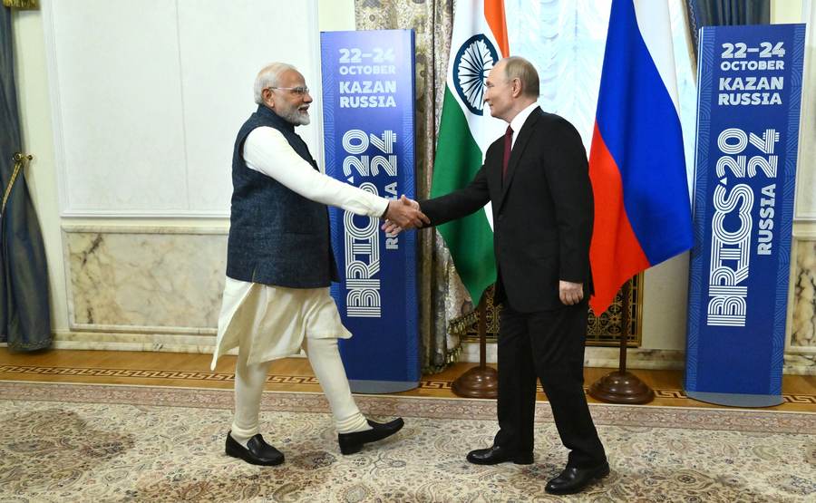 Narendra Modi and Vladimir Putin shake hands on the sidelines of the 2024 BRICS Summit in Kazan; the two leaders have met repeatedly since, most recently at the 18th BRICS Summit in New Delhi in September 2026.