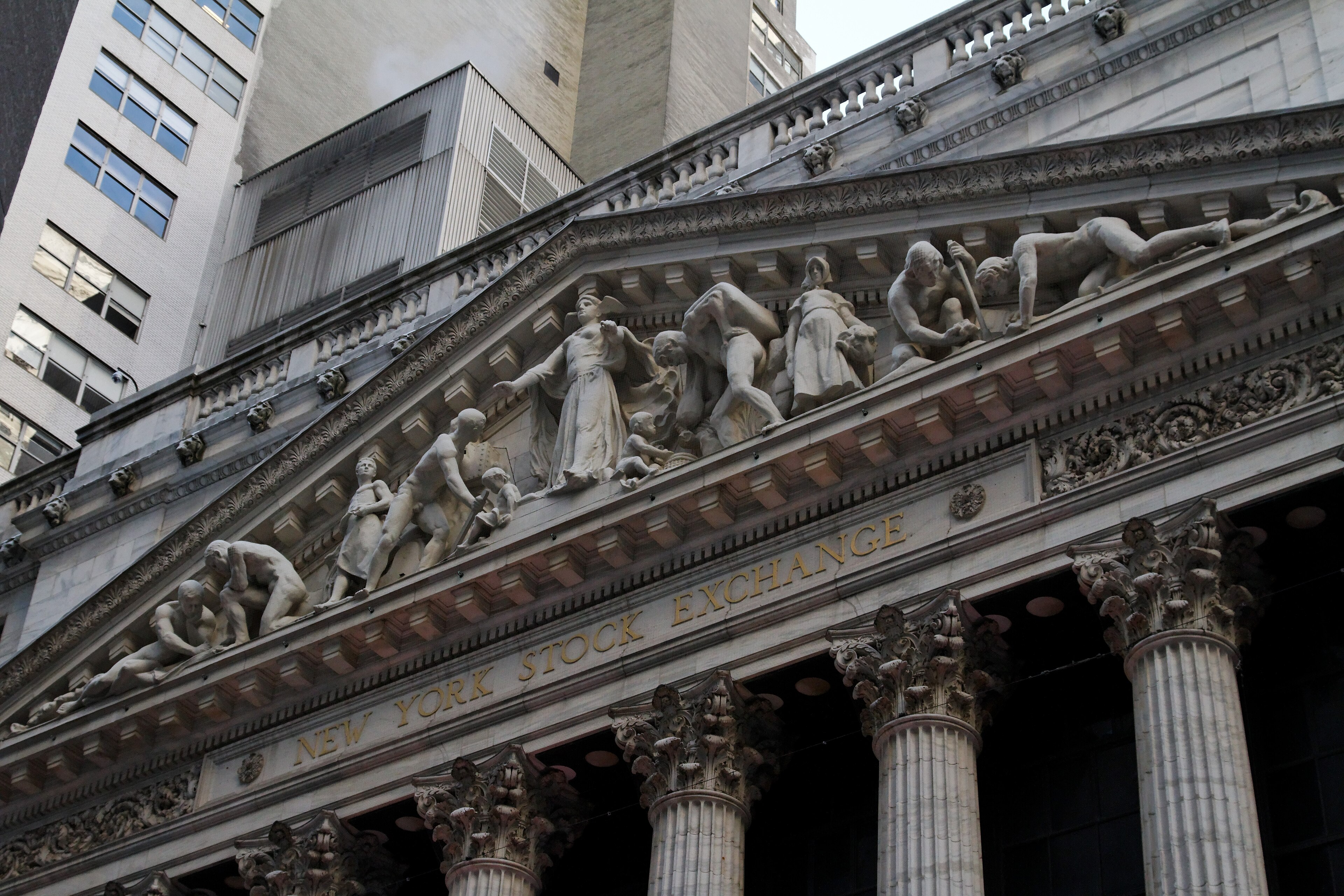 US PMI October 2026 — the pediment of the New York Stock Exchange, as the flash composite PMI eases to 57.6 from a five-year high