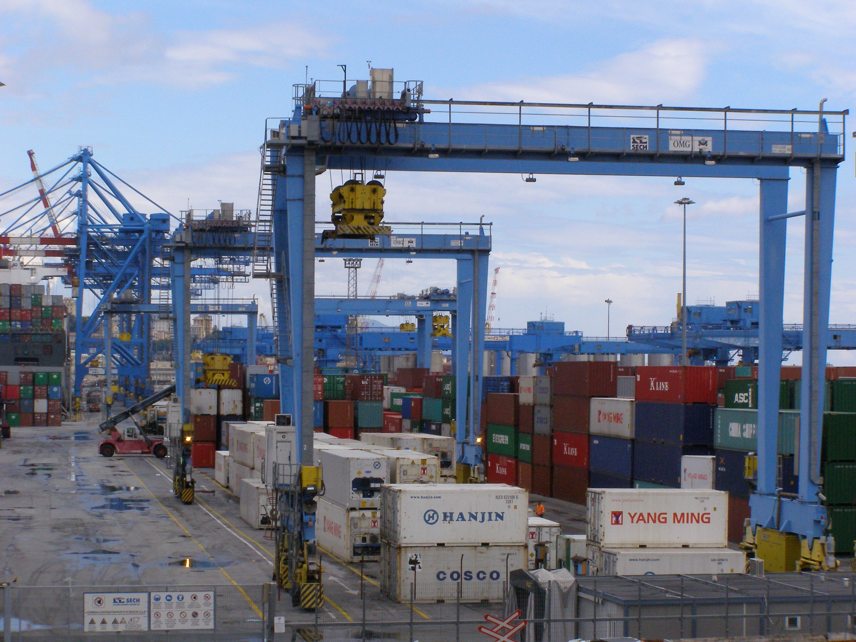 Container cranes and stacked shipping containers at the Port of Genoa container terminal in Italy, one of the hub ports named in the planned dockworkers strike over arms shipments
