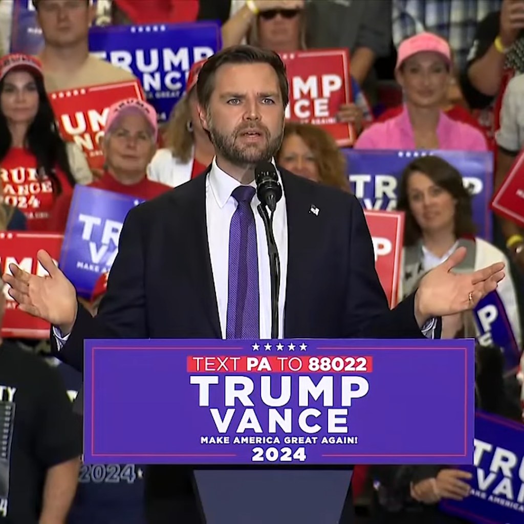 JD Vance speaking at a campaign rally podium in Wilmington, North Carolina, during the 2024 campaign — Vance defends Ramaswamy attack ad in Ohio