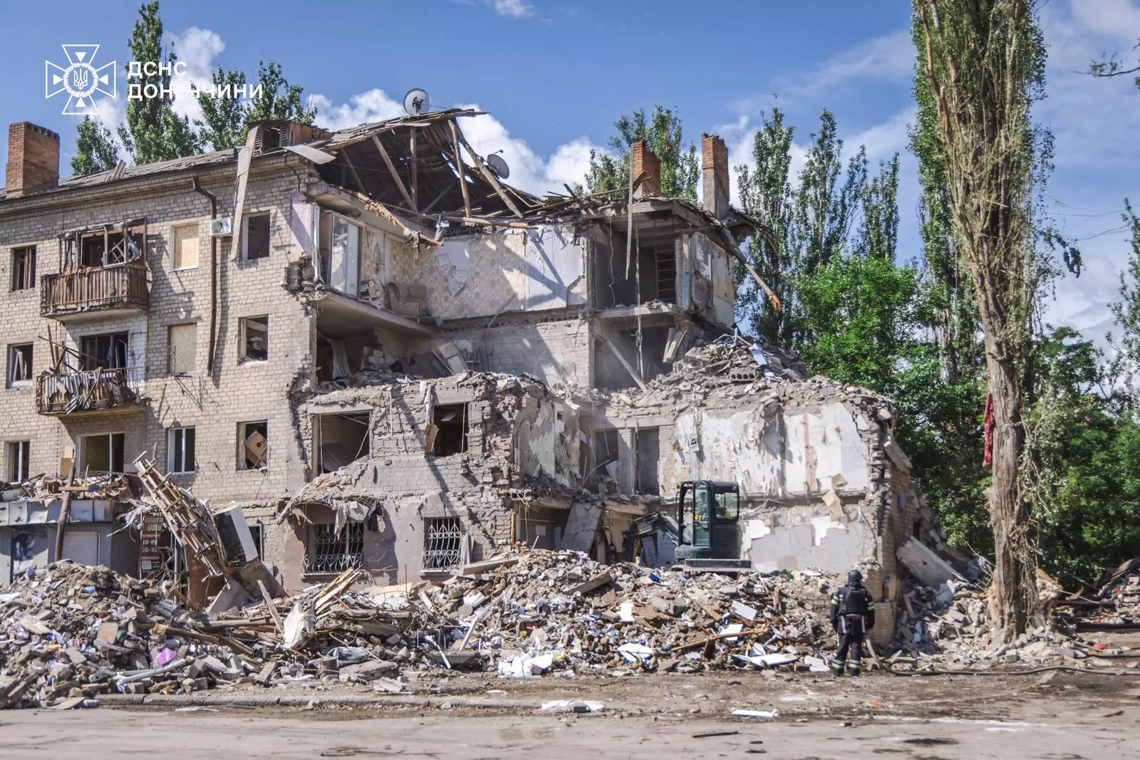 A collapsed apartment block in Kramatorsk with a rescuer standing in the rubble — file photo of earlier strike damage in the city