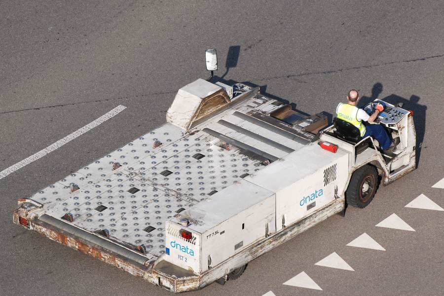 An aircraft cargo loader servicing a freighter