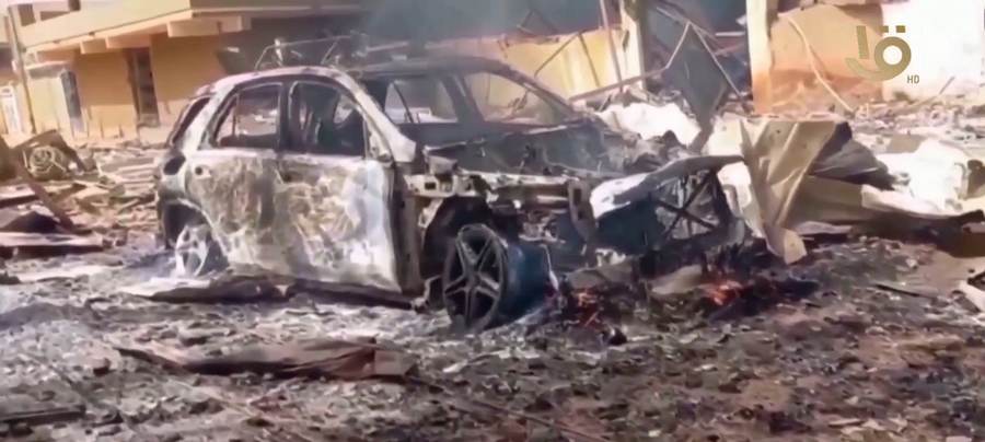 A destroyed car in El Fasher during the RSF siege — Sudan's army has now captured the RSF base at Sodari in North Kordofan, pushing the war's center westward.