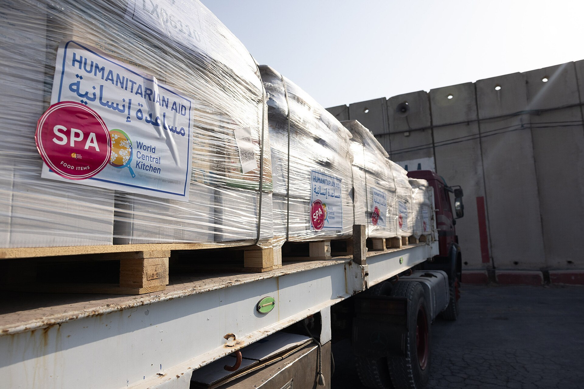 A flatbed truck loaded with shrink-wrapped humanitarian aid pallets at the Kerem Shalom crossing into Gaza — Gaza commercial goods halt file photograph