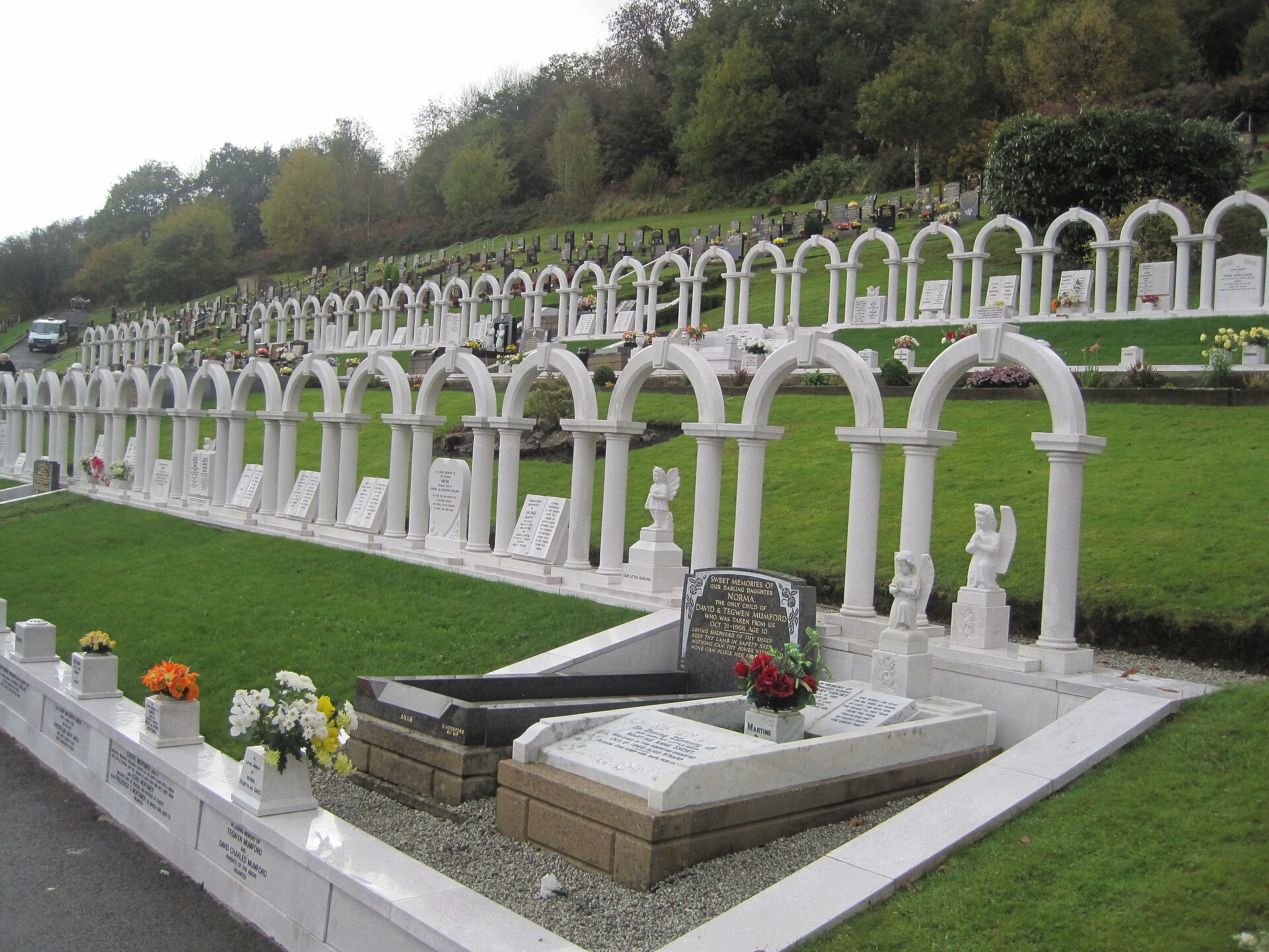 Aberfan cemetery memorial — the linked white arches at Bryntaf Cemetery marking the graves of the children killed in the Aberfan disaster
