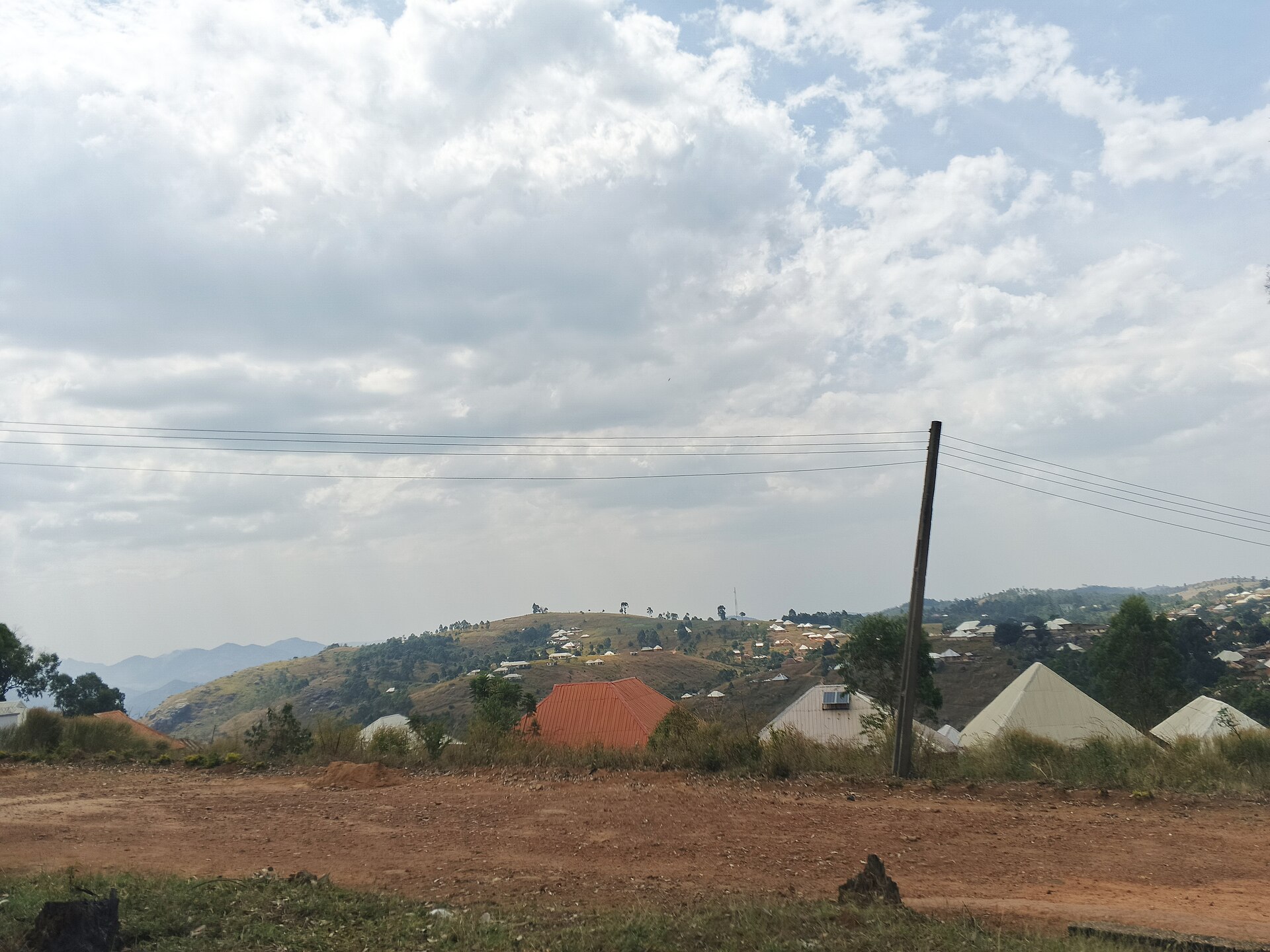 A rural settlement on the Mambilla Plateau in Taraba State, Nigeria, with scattered houses across green hills