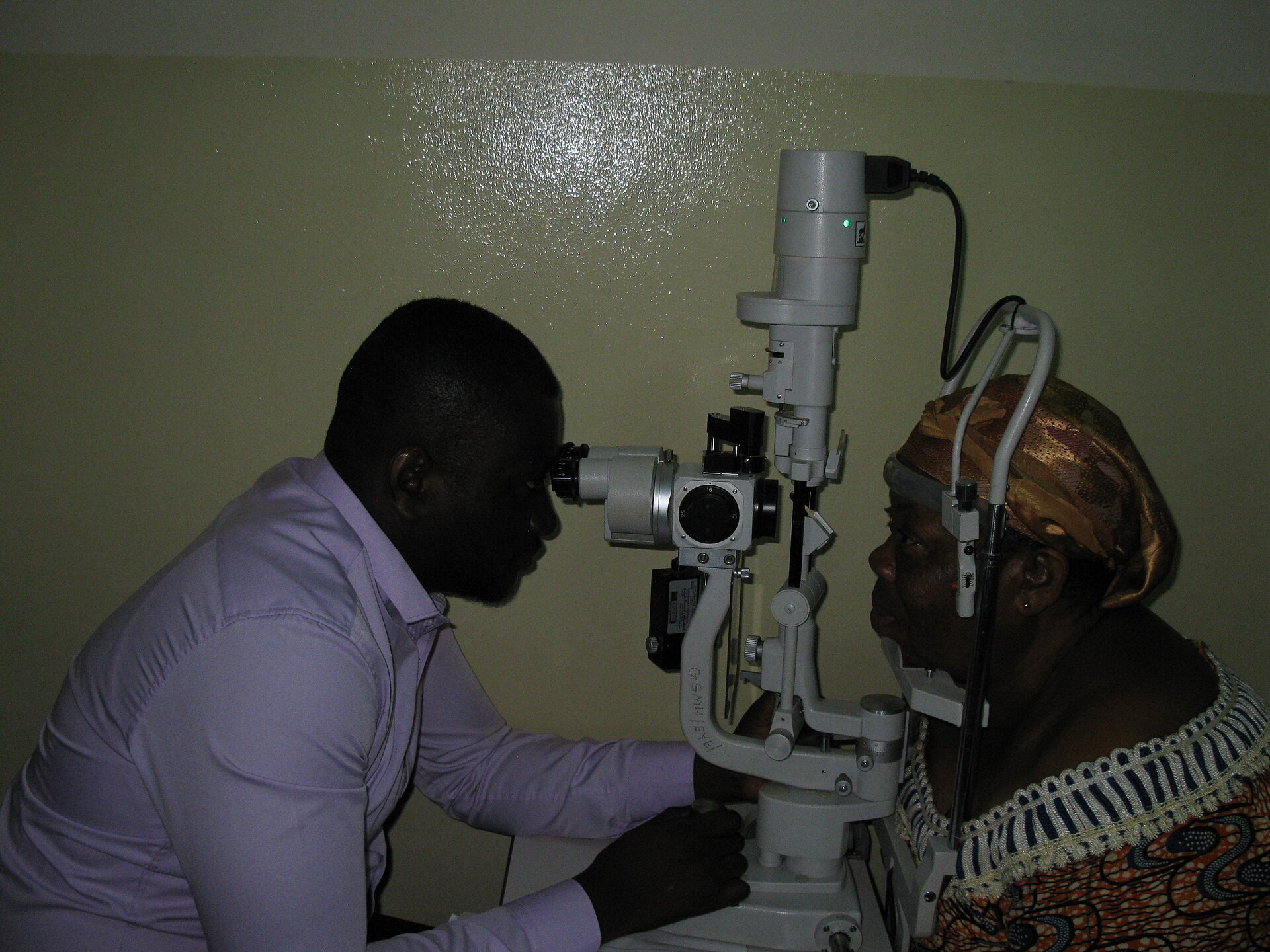 An optometrist performing a slit lamp eye examination — sudden vision changes on GLP-1 medicines need same-day eye care