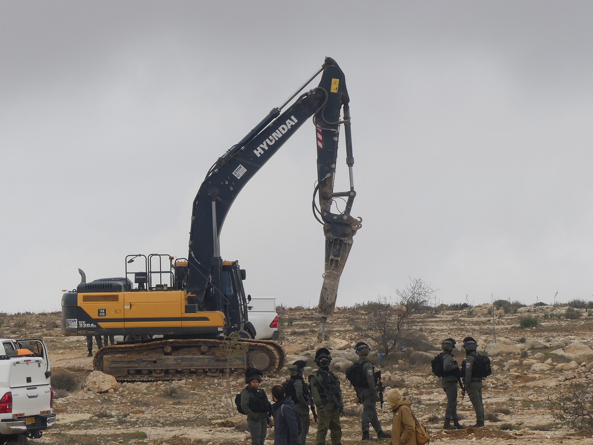 An Israeli military excavator fitted with a hydraulic breaker during the demolition of Palestinian homes at Khallet Athaba in the Masafer Yatta area of the South Hebron Hills — Israel demolishes homes in Hebron operation context, February 2025 file photo
