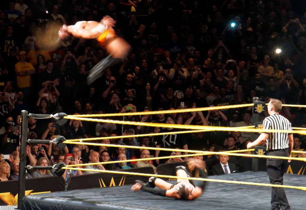Pac, performing as Neville in WWE, hits his signature Red Arrow corkscrew senton in April 2015. AEW announced the wrestler's death at age 40 on September 27, 2026