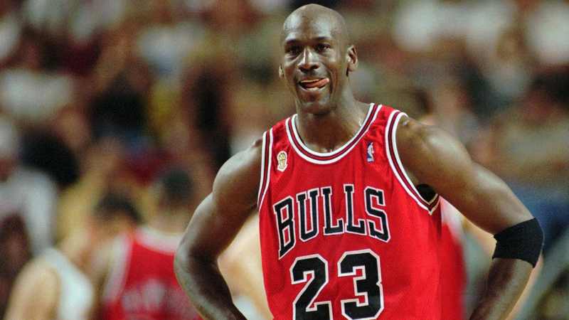 Michael Jordan in the red Chicago Bulls road jersey number 23 — the road colours he wore in Game 2 of the 1998 NBA Finals