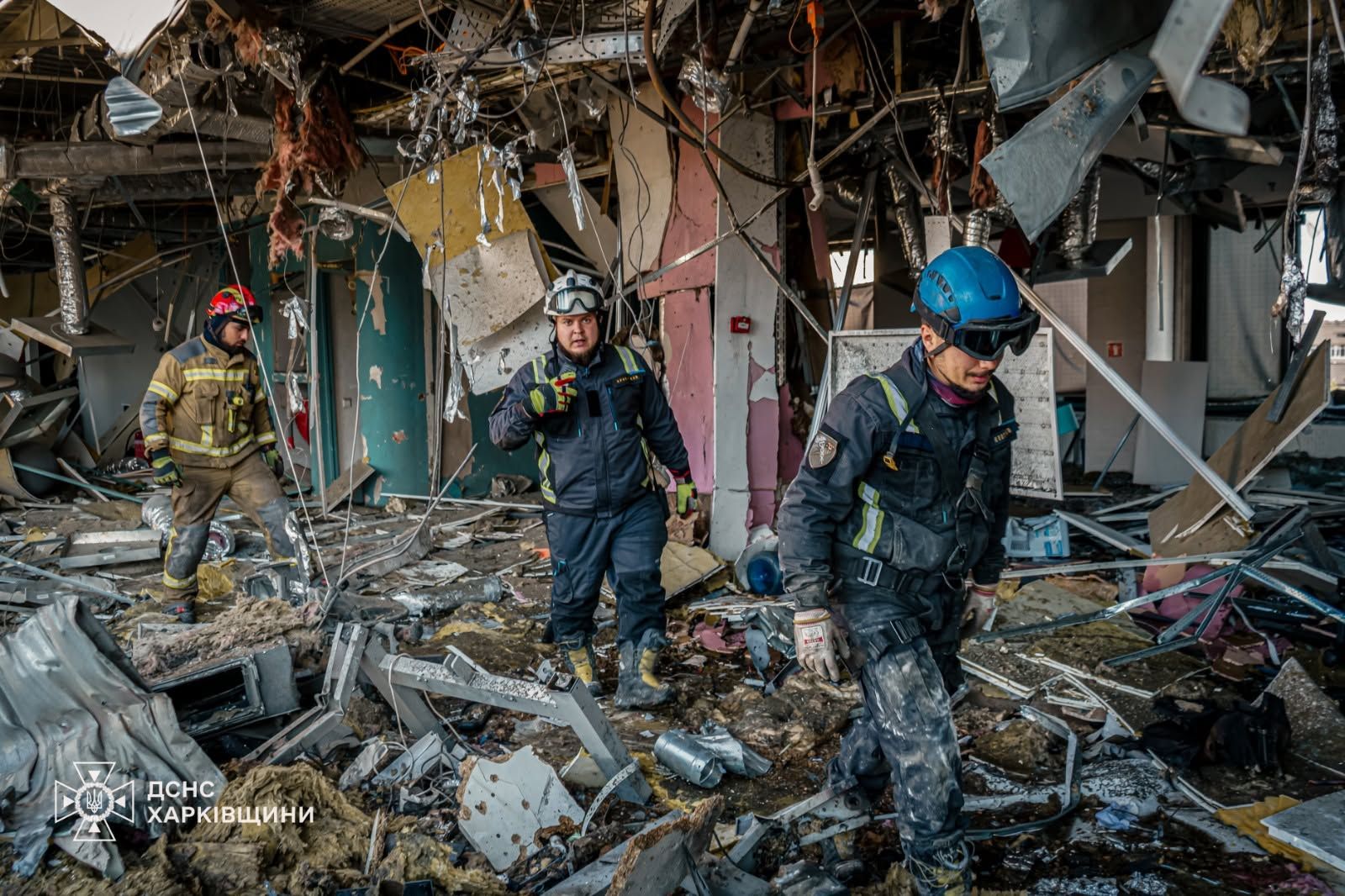 State Emergency Service rescuers pick through the interior of a destroyed building in the Kharkiv region — Kharkiv park drone strike file photograph