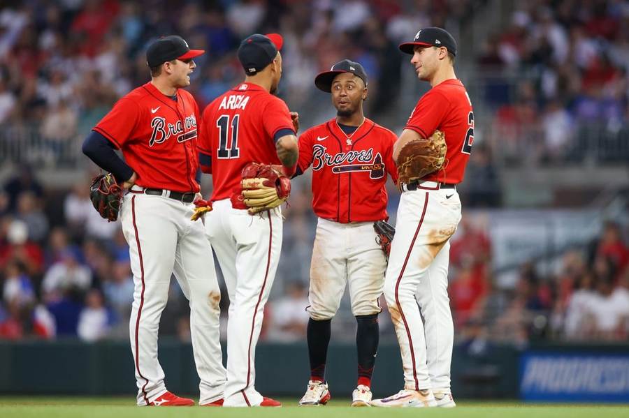 Atlanta Braves players gather on the infield before a game, representing the club that won Braves Phillies Game 3