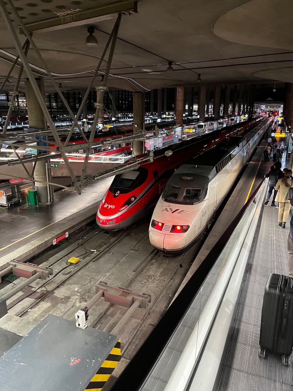 Spain train crash file photo: a Renfe AVE and a red Iryo Frecciarossa high-speed train side by side at Madrid Atocha station