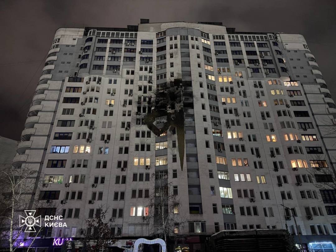 Ukrainian emergency workers at a damaged Kyiv building after a Russian attack in January 2026