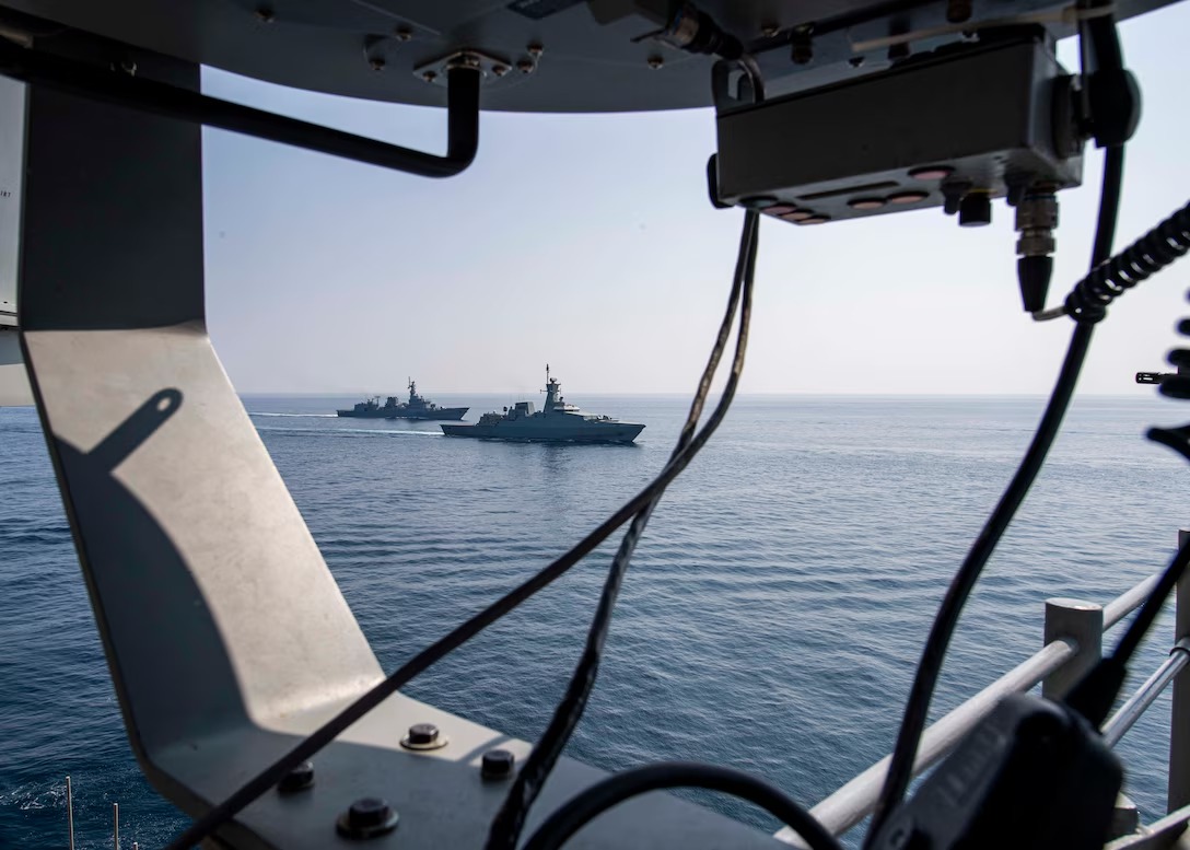The Royal Navy of Oman corvette Al Shamikh transiting in formation with USS Normandy during an exercise in the region