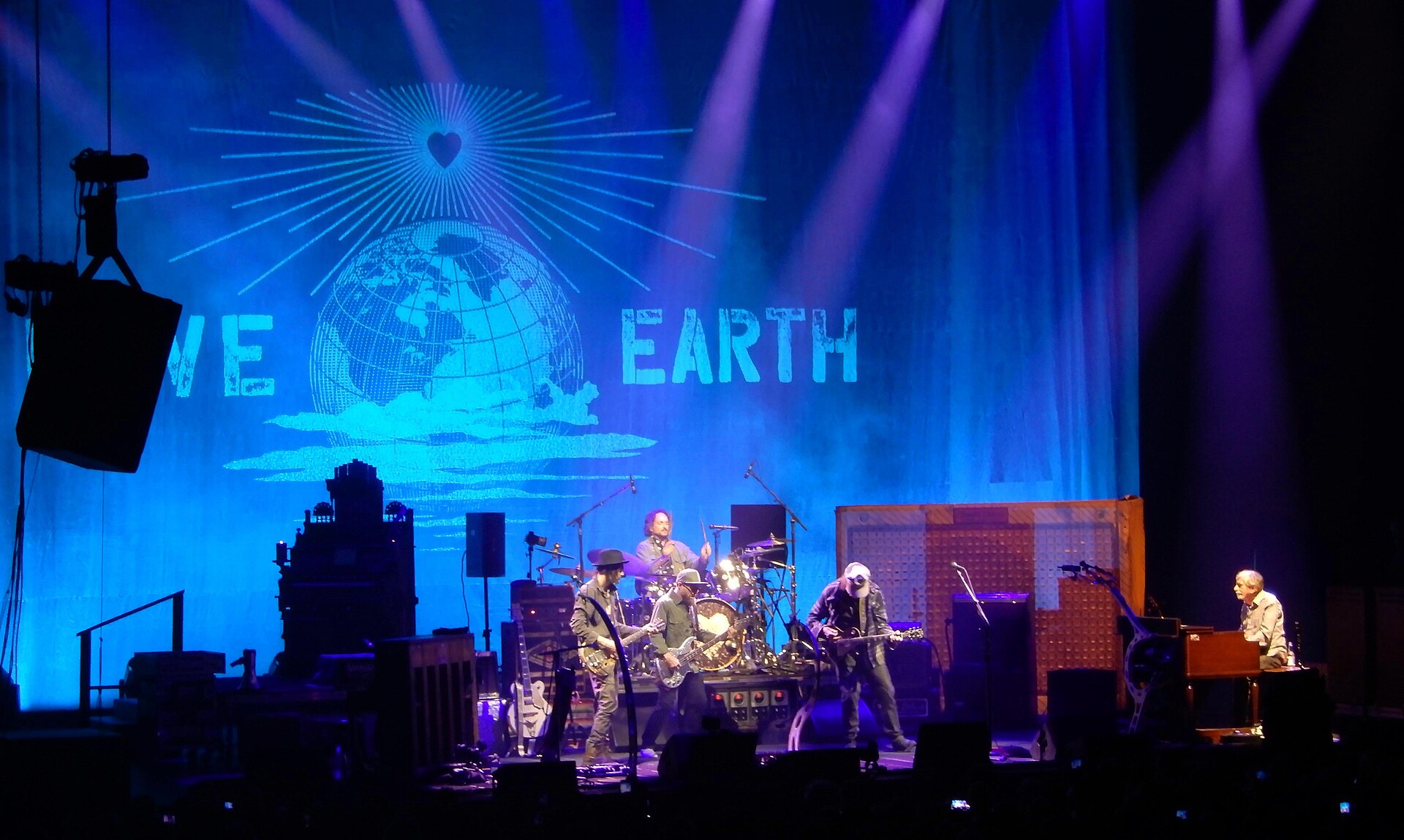 Neil Young performing on stage with his band the Chrome Hearts in Paris in July 2025, in front of a Love Earth backdrop — file photo