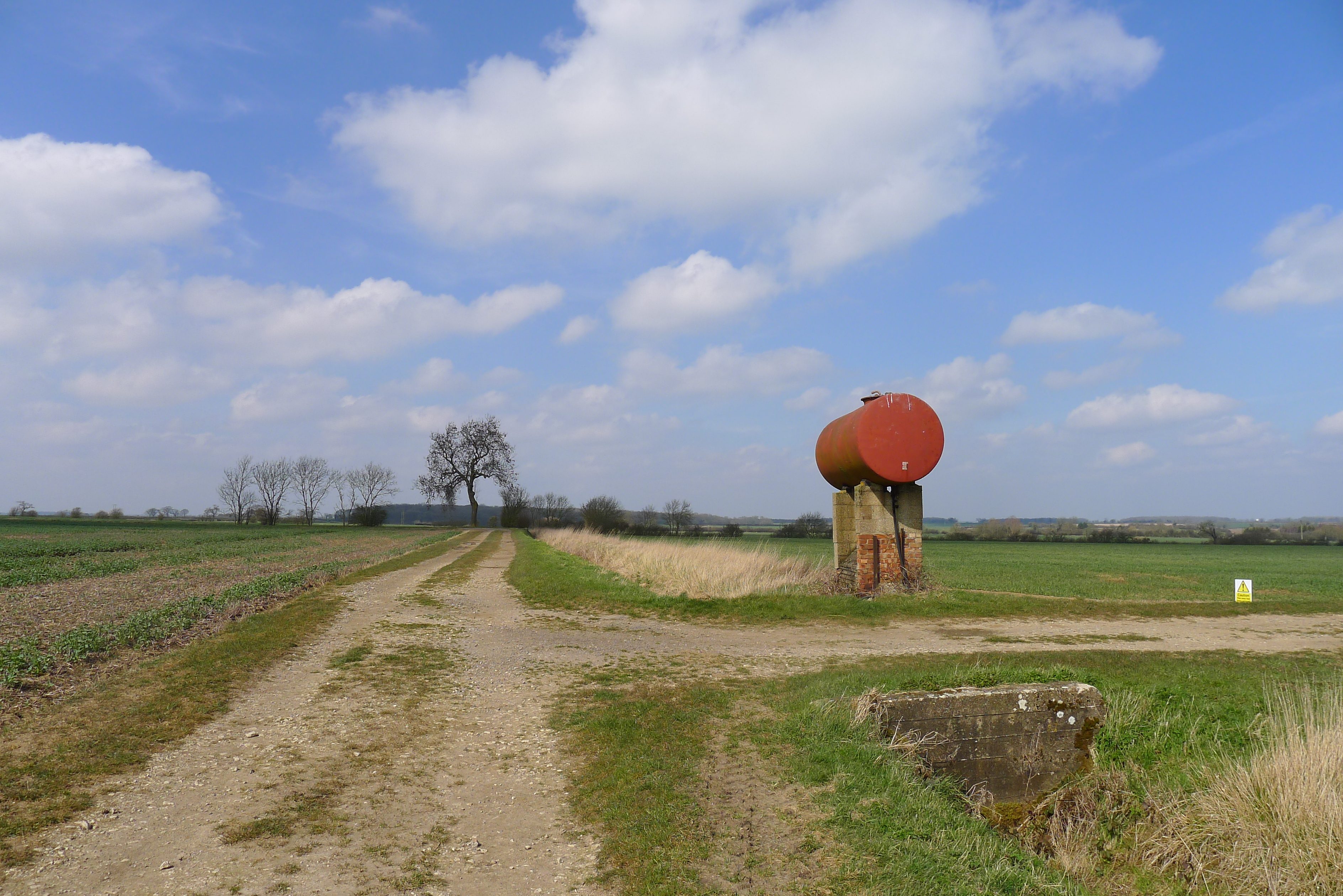 Trump red diesel tax exempt order — a red farm fuel storage tank beside farm tracks, file photo