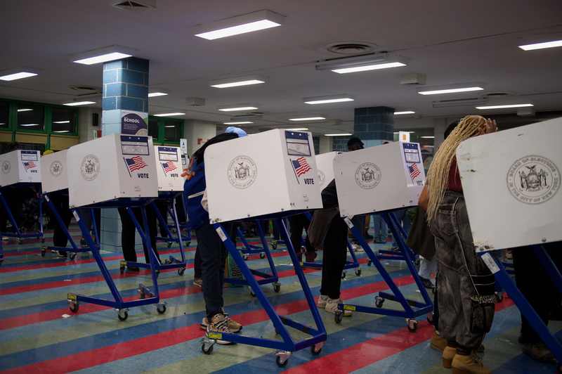 Voters casting ballots at a New York polling place as the Reuters Ipsos poll finds a midterm enthusiasm gap