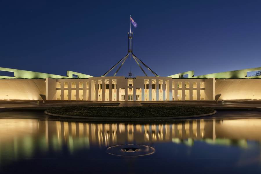 Parliament House in Canberra at dusk, where Australia's Senate inquiry will hold a public hearing on October 1 with AI company chiefs invited to testify